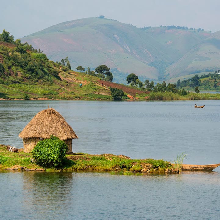 The green shoreline of Lake Kivu between the countries DR Congo and Rwanda in the heart of Africa. Lake Kivu is in the Albertine Rift, the western branch of the East African Rift. Lake Kivu empties into the Ruzizi River, which flows southwards into Lake Tanganyika.