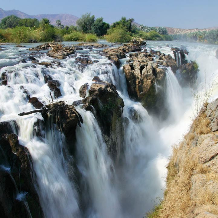 Epupa Falls (also known as Monte Negro Falls in Angola) is a series of large waterfalls created by the Cunene River on the border of Angola and Namibia, in the Kaokoland area of the Kunene Region.