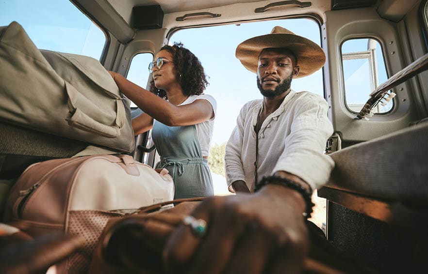 Travel luggage, black couple and car road trip together love bonding on nature safari holiday in Africa. Traveling, dating and black people, vehicle and bags for outdoor adventure vacation in Nigeria