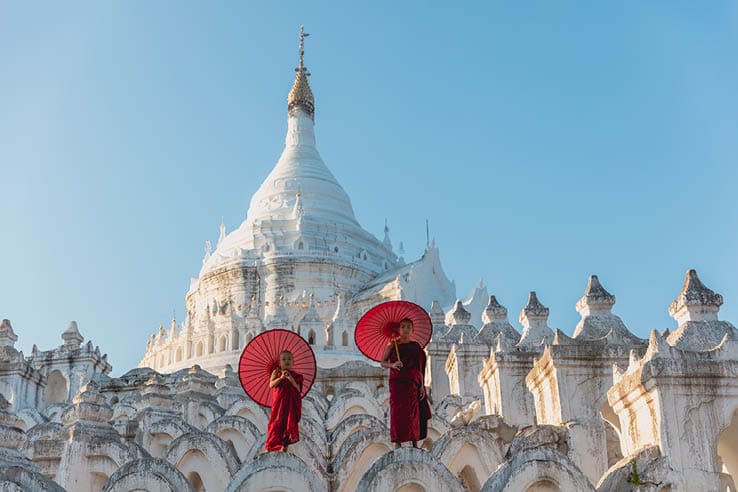 Novices under umbrellas at historic temple, Mingun, Mandalay, Myanmar