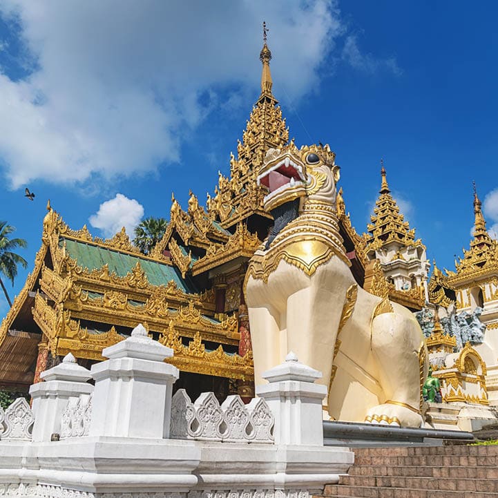 Golden ornamental south entrance gate with huge dragon statues to the famous Shwedagon Pagoda (Stupa) in downtown Yangon (Rangoon), Myanmar, Asia