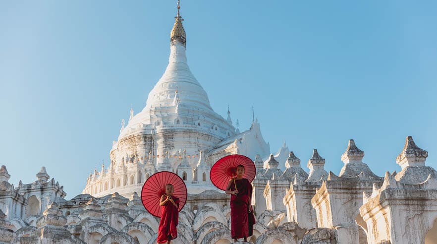 Novices under umbrellas at historic temple, Mingun, Mandalay, Myanmar