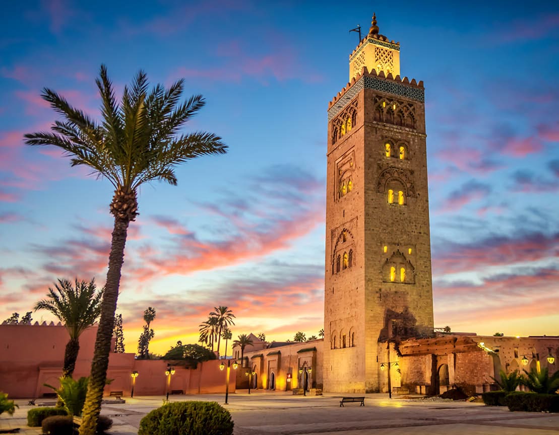 Koutoubia mosque in the morning surrounded by palm tree, Marrakesh, Morocco