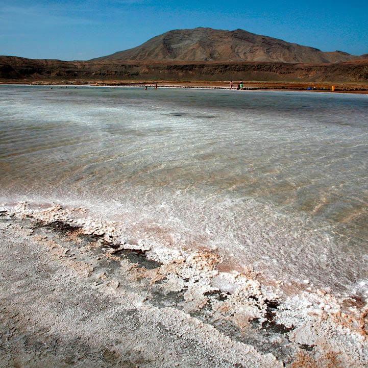 'Salinas' : Salt pans of Pedra de Lume, Inside the crater of a long extinct volcano, Midway up the east coast of Island of Sal, Cape Verde (Cabo Verde), off the West coast of Senegal (West Africa). Cape Verde, an Island Republic in the Atlantic. Formerly an overseas territory of Portugal, gained Independence on July 5th, 1975. 434,812 inhabitants (2000 census). Capital: Praia, Santiago Island.  Sal Surface : 216 km2. 30km long, 12km large. Approx. 14,792 inhabitants. One of the 3 sandy eastern islands of the archipelago. (Ten islands, Nine inhabited). Also the flattest and the driest of all Cape Verde islands. No ground water founded. All water supplies are brought by boat on containers from Praia or elsewhere.  Sal Island has been discovered circa 1460 by Portuguese and named after the Salt Laguna founded in the South and at 'Pedra de Lume', the crater of an extinct volcano. Salt export business exploited from early 19th century attracted many newcomers and brought a relative prosperity till its decline in the first half of the 20th century. By 1985, the salinas ceased all operations. In 1990, there were still 700 residents in Pedra de Lume. Unfortunately, the economy of the town only offers a handful of job opportunities, so the rest had to migrate to other parts of Sal or abroad. The site has now been turned into a resort.