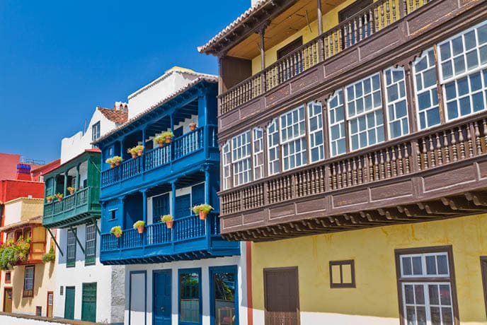 Colored balconies along Avenida Maritima, the street facing the sea in Santa Cruz de la Palma, the capital of La Palma Island. The town is located along an old lava flow coming out from a volcano located just south of the city. It has beautiful colonial buildings and pedestrian streets, where it is pleasant to walk discovering the city. La Palma, Canary Islands, Spain. Canon EOS 7D.