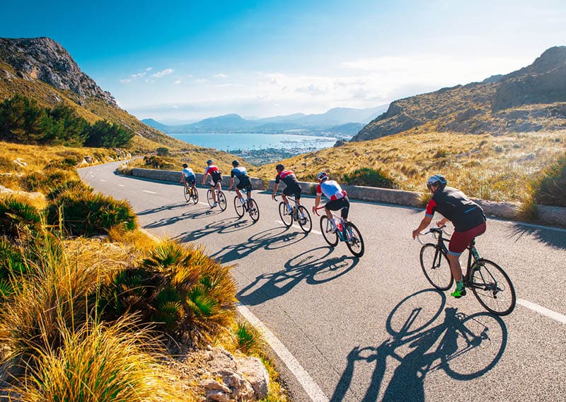 Team sport cyclist photo. Group of triathlete on bicycle ride on the road at Mallorca, Majorca, Spain.