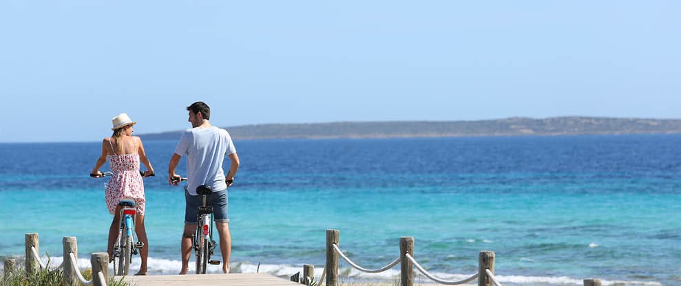 Couple riding bikes on Formentera Island