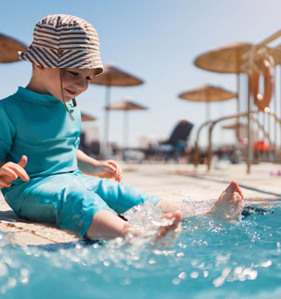 Toddler boy enjoying a day at the swimming pool.