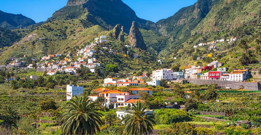 Hermigua and the town's landmark , the characteristic twin rocks Roques de San Pedro. Hermigua is a town and a municipality in the northeastern part of La Gomera in the province of Santa Cruz de Tenerife of the Canary Islands, Spain. It is located 12 km northwest of the island's capital, San Sebasti n de la Gomera. The Garajonay National Park covers the southern part of the municipality.