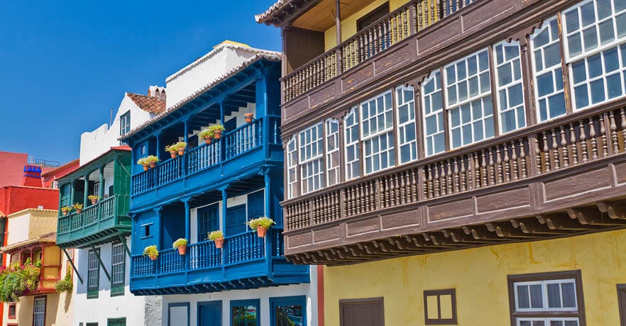 Colored balconies along Avenida Maritima, the street facing the sea in Santa Cruz de la Palma, the capital of La Palma Island. The town is located along an old lava flow coming out from a volcano located just south of the city. It has beautiful colonial buildings and pedestrian streets, where it is pleasant to walk discovering the city. La Palma, Canary Islands, Spain. Canon EOS 7D.