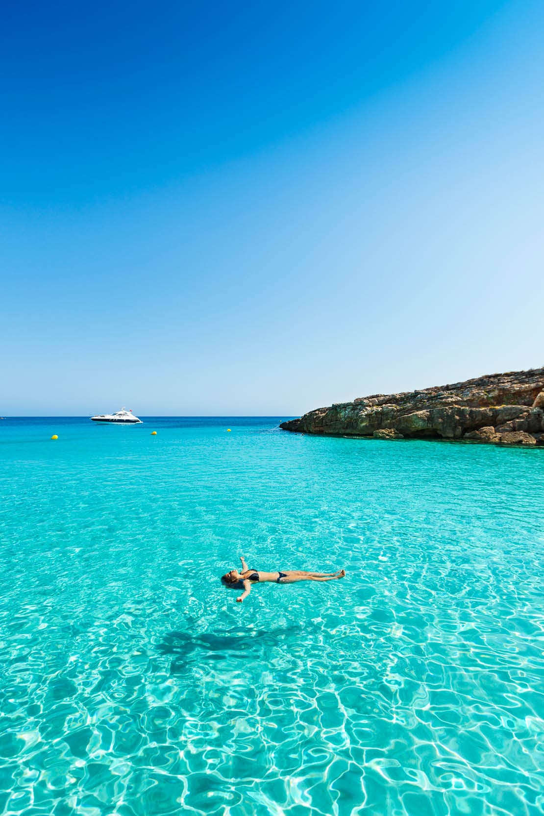 Idyllic holidays: girl floating in fresh clean turquoise water.