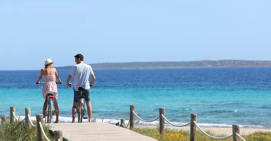 Couple riding bikes on Formentera Island