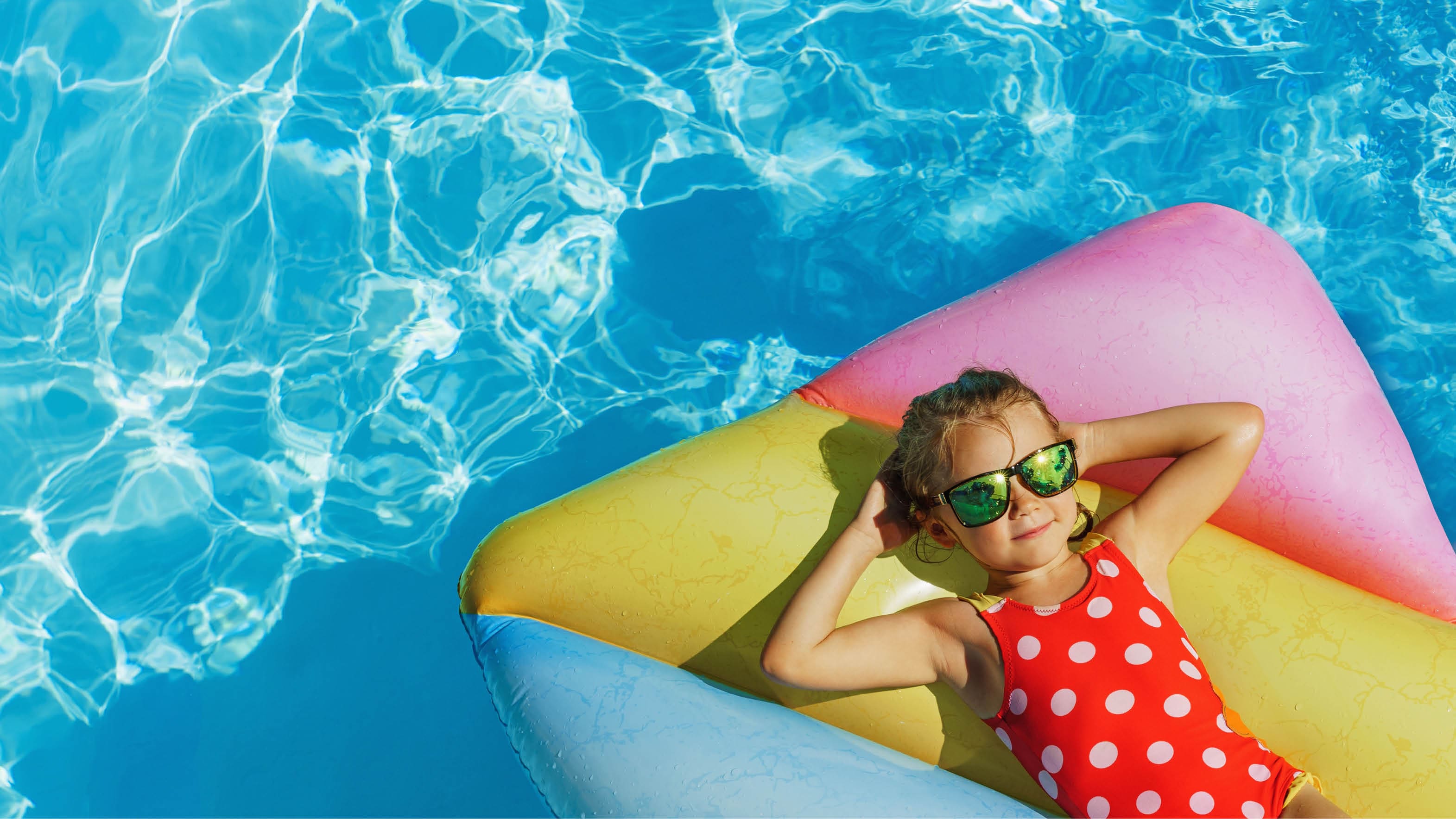 Child in swimming pool. Having fun on vacation at the hotel pool. Colorful vacation concept.; Shutterstock ID 2140684337; purchase_order: -; job: -; client: -; other: -