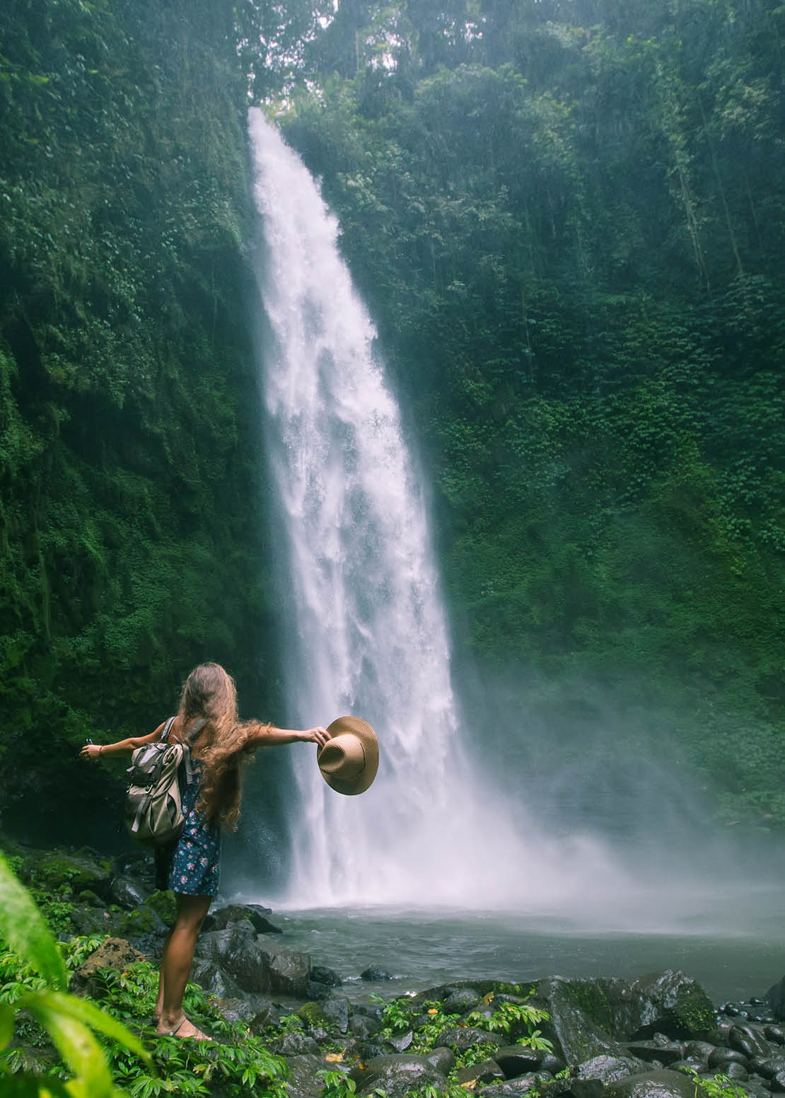 Woman near Nung Nung waterfal on Bali, Indonesia