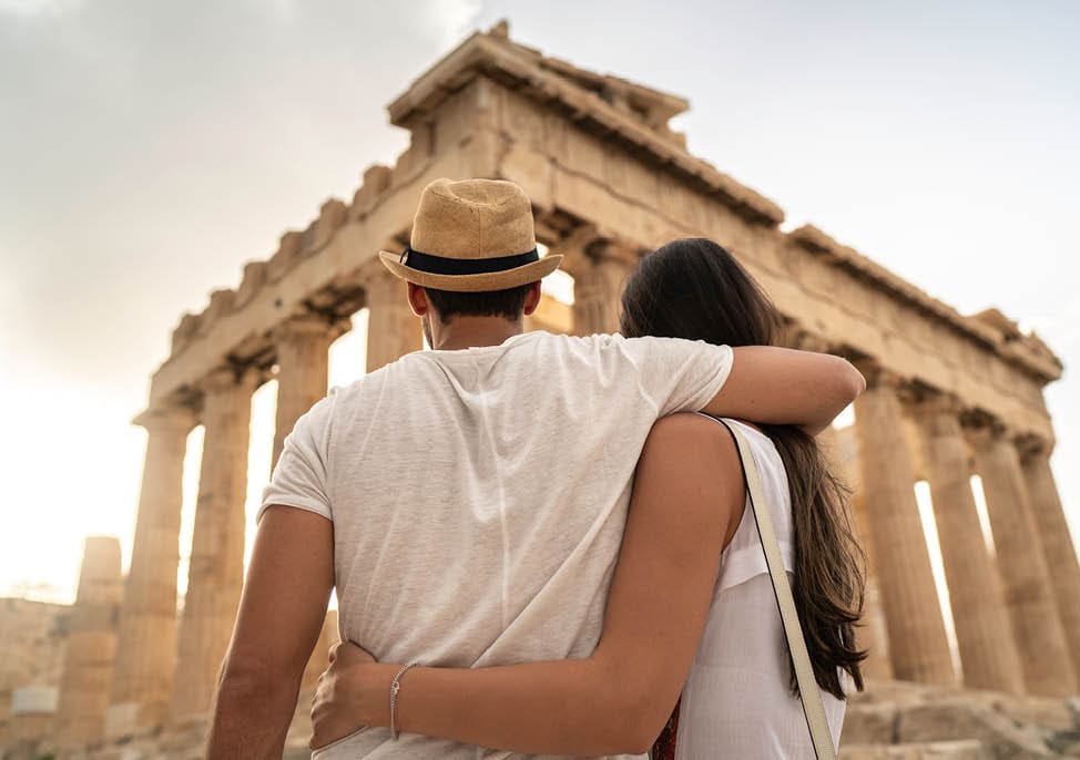 Rear View Of A Young Couple Embracing Standing In The Acropolis, Athens