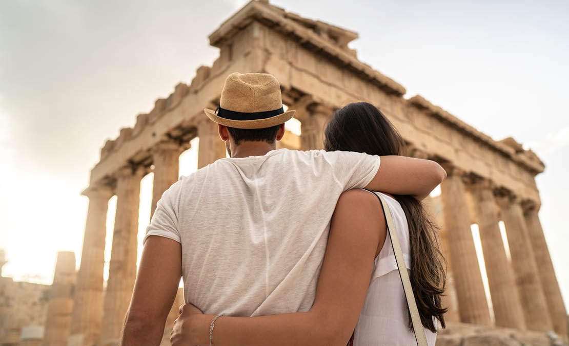 Rear View Of A Young Couple Embracing Standing In The Acropolis, Athens