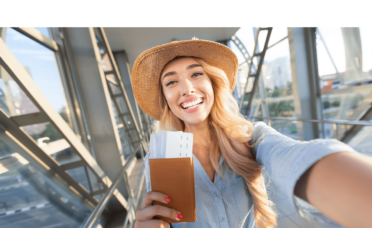 Enjoy traveling. Beautiful woman taking selfie in airport, waiting for boarding