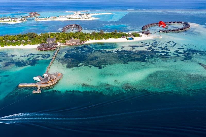 Aerial view, paraglider flies along an atoll of Maldives, South Male Atoll Maldives