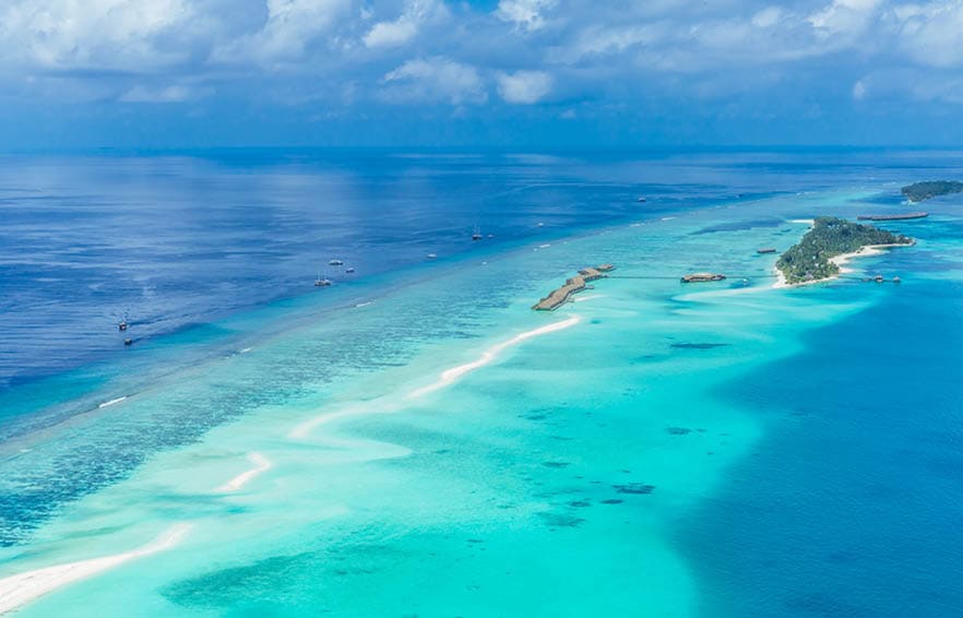 Aerial view on Maldives island, Ari atoll. Tropical islands and atolls in Maldives from aerial view. Summer vacation holiday landscape background.