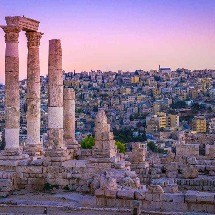 Amman, Jordan its Roman ruins in the middle of the ancient citadel park in the center of the city. Sunset on Skyline of Amman and old town of the city with nice view over historic capital of Jordan.