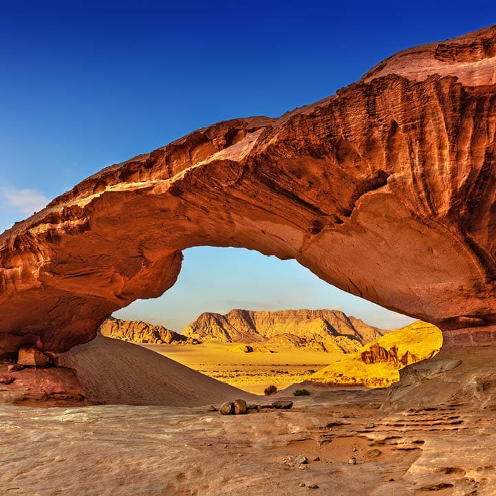View through a rock arch in the desert of Wadi Rum, Jordan, Middle East