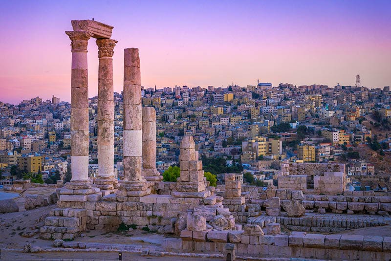 Amman, Jordan its Roman ruins in the middle of the ancient citadel park in the center of the city. Sunset on Skyline of Amman and old town of the city with nice view over historic capital of Jordan.