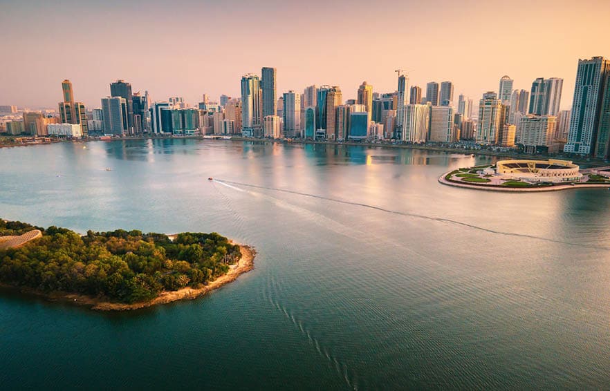 Emirate of Sharjah cityscape waterfront rising above Al Noor Island at city downtown in the United Arab Emirates