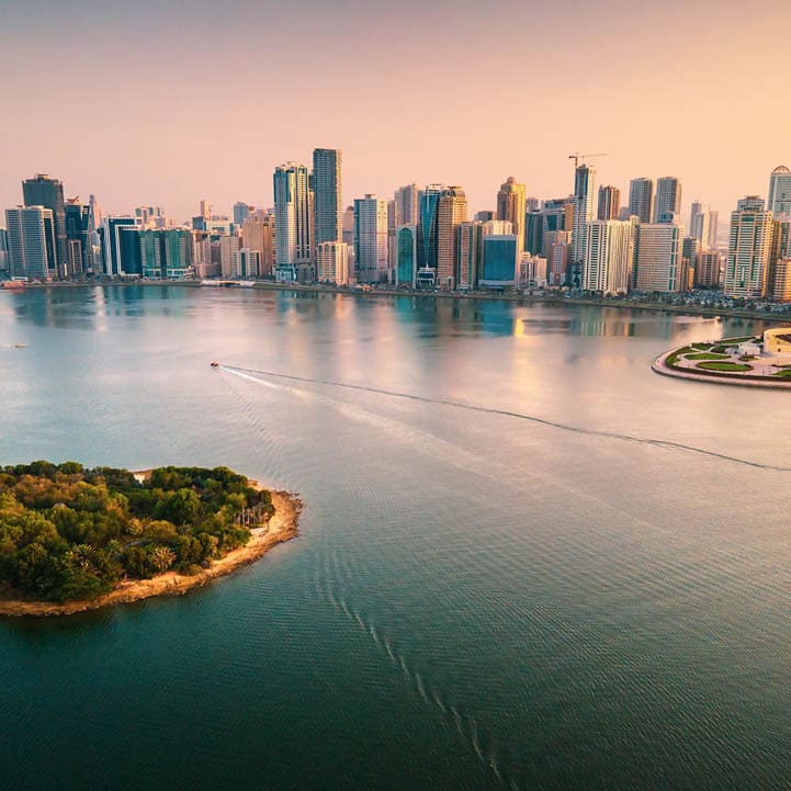 Emirate of Sharjah cityscape waterfront rising above Al Noor Island at city downtown in the United Arab Emirates