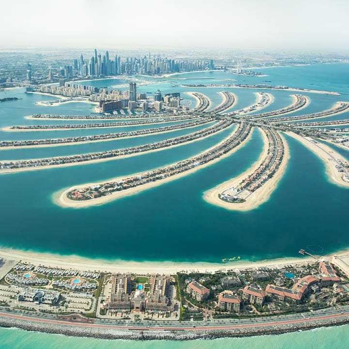 Aerial view of Palm Jumeirah man made island and Dubai Marina and JBR district on a sunny day. Dubai, UAE.