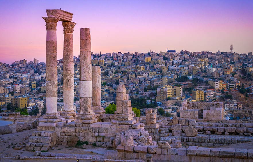 Amman, Jordan its Roman ruins in the middle of the ancient citadel park in the center of the city. Sunset on Skyline of Amman and old town of the city with nice view over historic capital of Jordan.