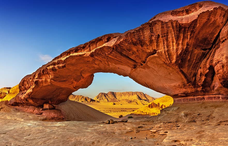 View through a rock arch in the desert of Wadi Rum, Jordan, Middle East