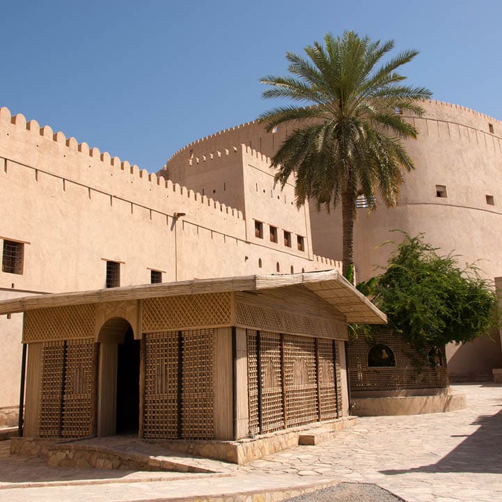 Empty courtyard with tower at the16th Century castle in Nizwa, Oman.