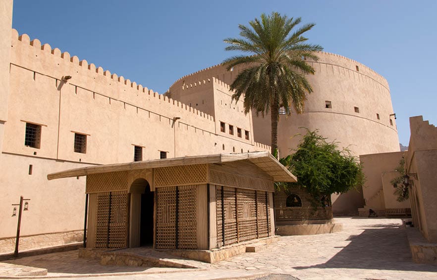 Empty courtyard with tower at the16th Century castle in Nizwa, Oman.