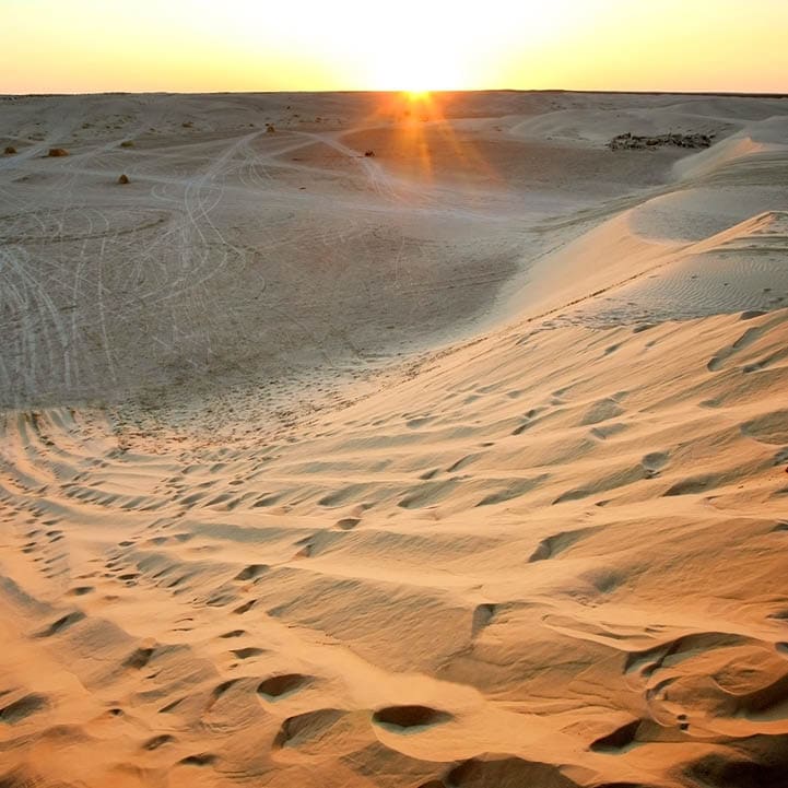View at sunset on the dunes of Ong Jemel in the Sahara Desert in Tunisia.