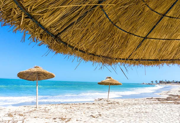 Landscape of parasols on the beach of Djerba in Tunisia 