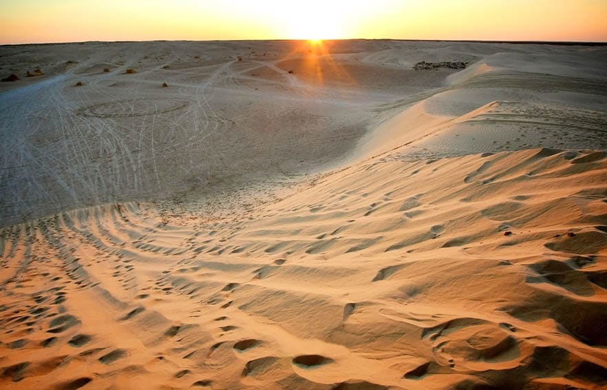 View at sunset on the dunes of Ong Jemel in the Sahara Desert in Tunisia.