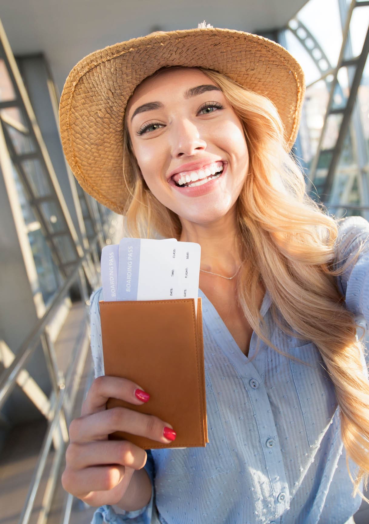 Enjoy traveling. Beautiful woman taking selfie in airport, waiting for boarding