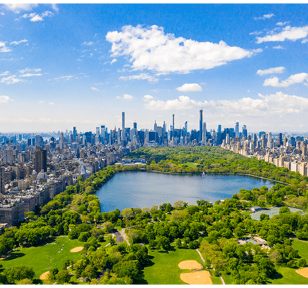 Aerial view of the Central park in New York with golf fields and tall skyscrapers surrounding the park.