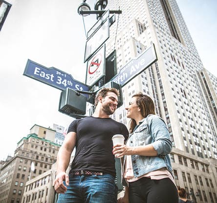 Happy couple walking outdoors on the streets - Two tourists visiting a city - Lovers having a romantic walk